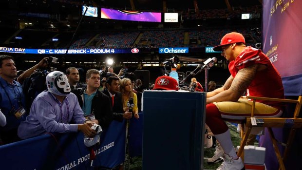 Colin Kaepernick of the San Francisco 49ers answers questions from the media, including a wrestling devotee.