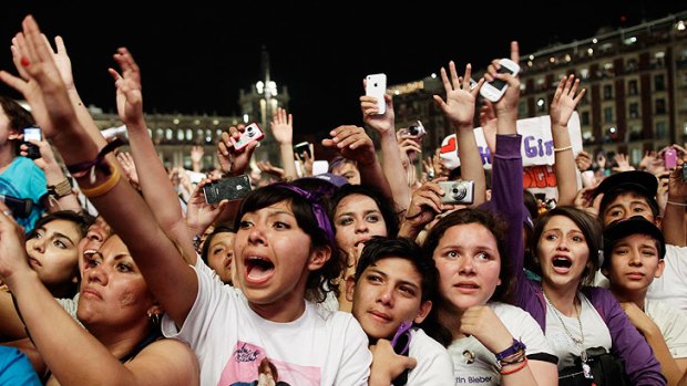 Fans scream in excitement during the open-air concert in Zocalo Square.