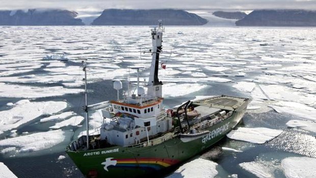Greenpeace ship Arctic Sunrise pictured in cracked and drifting ice in front of the Petermann Glacier (out of view) on Greenland's north-west coast.