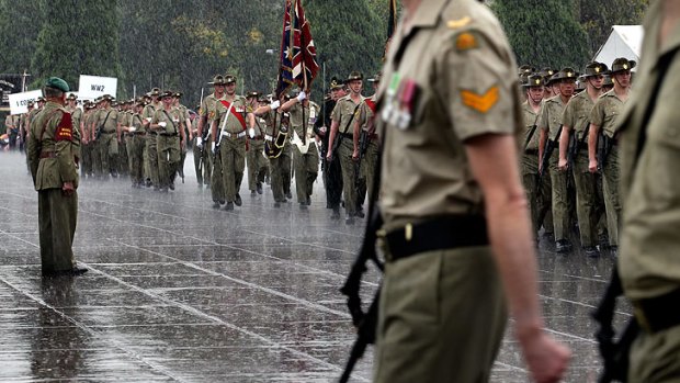 Wet but not wearied ... Serving members march in the rain.