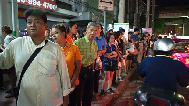 commuters wait for taxis or motorbike taxis as they rush home after a curfew was imposed following the coup.