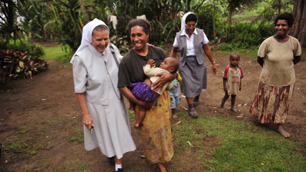 Sister Rose Bernard (left) in a village in Banz.