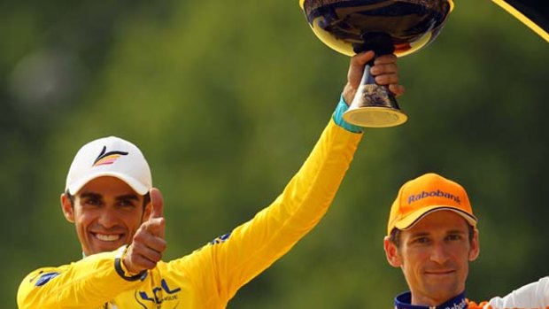Alberto Contador of team Astana celebrates with his traditional pistol pose after winning this year's Tour de France.