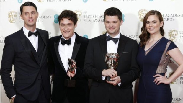 <i>The Lego Movie</i> directors Phil Lord (second left) and Christopher Miller celebrate with presenters Hayley Attwell (right) and Matthew Goode after winning the award for best animated film at the British Academy of Film and Arts awards ceremony in London.