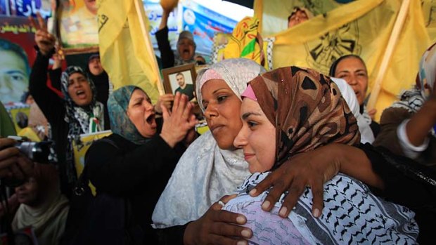 Relatives of Palestinian prisoners celebrate the signing of a deal by inmates to end a hunger strike.