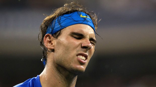 Rafael Nadal grimaces during last year's US Open final against Novak Djokovic. The Spaniard has announced he won't play in this year's tournament because of a knee injury.
