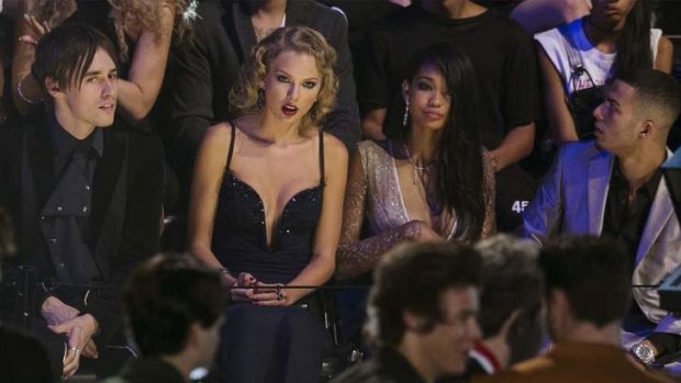 Taylor Swift (second left) reacts as she listens to members of the band One Direction accept the award for song of the summer.