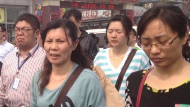 Liu Fenghua (3rd from right), mother of a missing MH370 passenger, marches with other relatives to the Malaysian consulate in Beijing.
