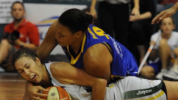 Pancake maker &#8230; Bulleen's Liz Cambage puts a hit on Jenna O'Hea of Dandenong during a bruising WNBL final in Melbourne yesterday.