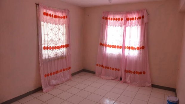 Pink curtains adorn an empty room that once belonged to Dwayne Jones.