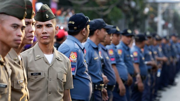 Huge security force ... Philippines armed forces and police officers secure President Quirino Avenue for the arrival of Pope Francis.