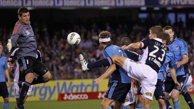 Saving grace ... Sydney goalkeeper Liam Reddy stops a shot from Melbourne Victory defender Adrian Leijer.