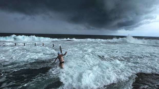 Maroubra Seals winter swimming club members brave the wild weather at Mahon pool.