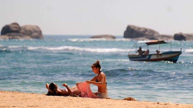 Tourists rest on a beach of Sri Lanka's southern coastal town of Hikkaduwa.