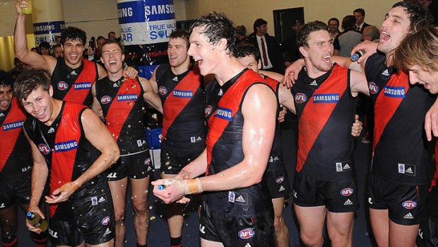 The Bombers celebrate their one-point victory in a see-sawing match.