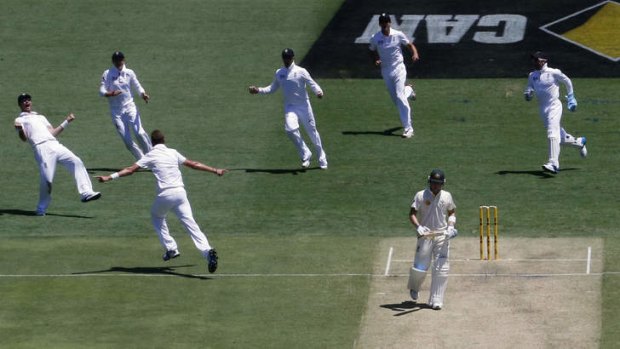 On his way: Stuart Broad charges towards teammates after dismissing Michael Clarke for one just after lunch.