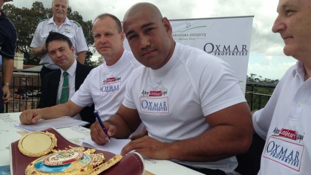 Logan boxer Alex Leapai, with trainer Noel Thornberry and Phil Murphy of sponsor Oxmar Properties, at Mt Coot-tha inking the deal for his world title fight.