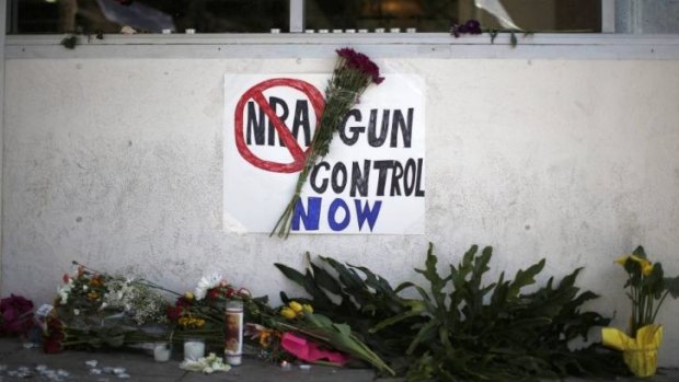 A sign advocating gun control is seen on a makeshift memorial for 20-year-old university student Christopher Michael-Martinez.
