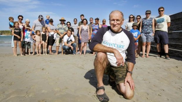Coastcare volunteer Nick Glover (front) and Warrnambool residents are concerned about cuts to the program that helps conserve their beaches.