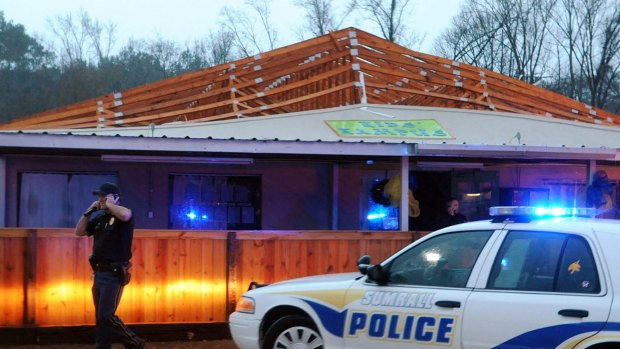 Police inspect Kid's Kampus, a daycare facility after a tornado ripped the roof off of the building in Sumrall, Mississippi.