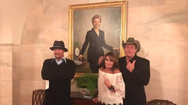 Kid Rock, Sarah Palin and Ted Nugent in front of a Hillary Clinton portrait during their White House visit.