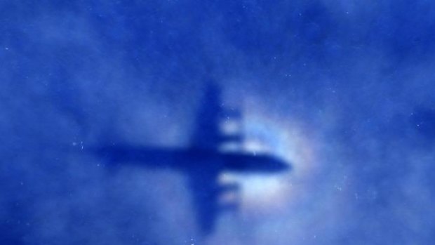 The shadow of a Royal New Zealand Air Force P3 Orion  can be seen on low-level clouds as it flies over the southern Indian Ocean looking for missing Malaysian Airlines Flight MH370.