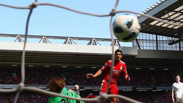 Luis Suarez of Liverpool scores the third goal.