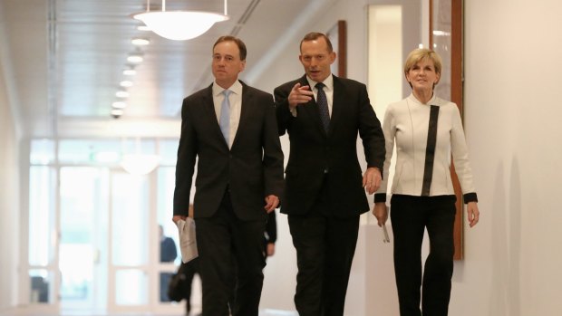 Prime Minister Tony Abbott arrives for a press conference on climate targets with Environment Minister Greg Hunt and Foreign Affairs Minister Julie Bishop.