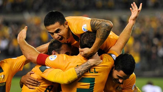 Tim Cahill (Aus) celebrates Lucas Neill's goal with teamates.
