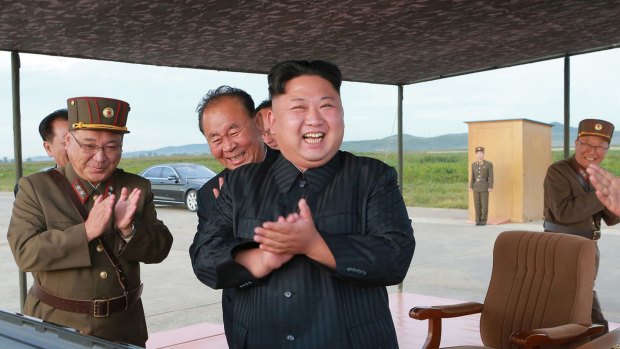 North Korean leader Kim Jong-un, center, celebrates his latest missile test launch on Friday. Independent journalists were not given access.