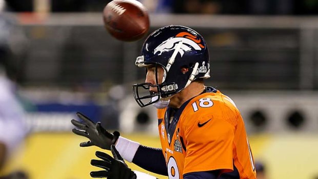 Shocking start: the ball flies over the head of quarterback Peyton Manning.