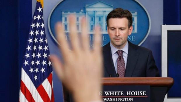 White House spokesman Josh Earnest fields a question about Ebola during a press briefing in Washington.