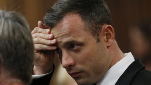 Olympic and Paralympic track star Oscar Pistorius confers with members of his legal team on the third day of his murder trial in Pretoria on March 5. 