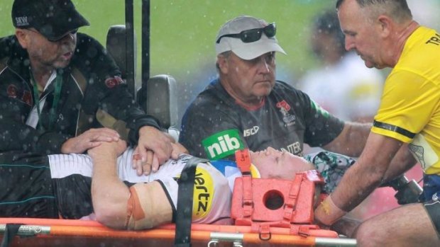 Mothers' Day scare: Nigel Plum is stretchered off.