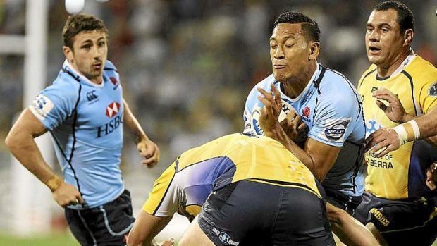 No way through: Israel Folau of the Waratahs runs into some heavy defence against the Brumbies in Canberra on Saturday night.