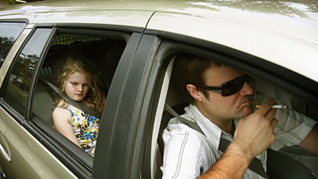 Banned ... smoking in cars with children under 16 will be illegal from next January in Queensland.