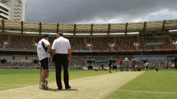 England's Andrew Strauss and chairman of selectors Geoff Miller inspect the Gabba wicket during their last visit to Brisbane in 2010.