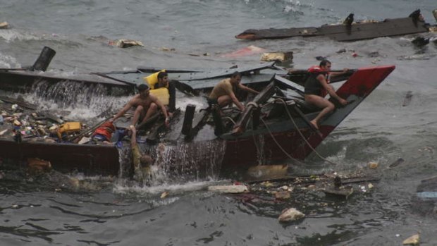 The sinking of an asylum seeker boat off Christmas Island in December 2010. Customs officer Myles Pickett has received a bravery award for his efforts to rescue asylum seekers.