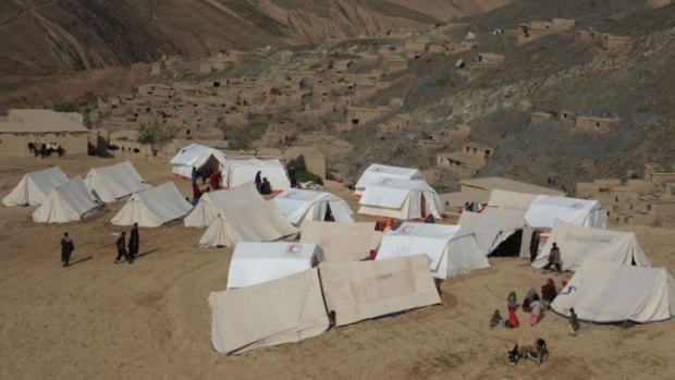 Villagers take shelter in relief tents near the scene of the incident.