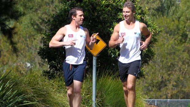 Pounding the pavement ... ex-Rooster Luke Ricketson with trainer Ben Lucas  yesterday.