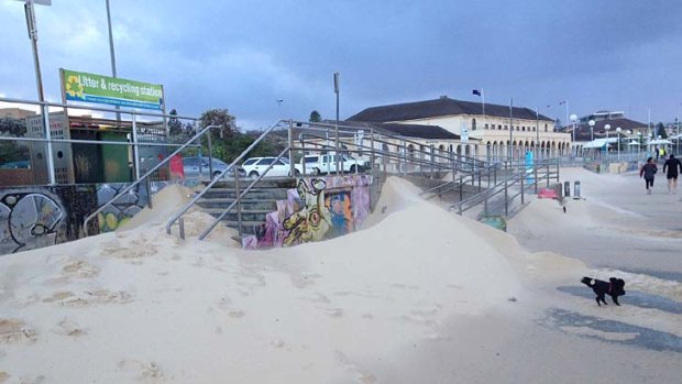 Sand has been blown on to the promenade at Bondi Beach.
