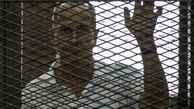 Peter Greste inside the defendant's cage at court during his trial.