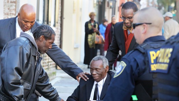 John Pinckney, father of shooting victim Reverend Clementa Pinckney, is greeted after leaving the Courthouse in Charleston in December. 