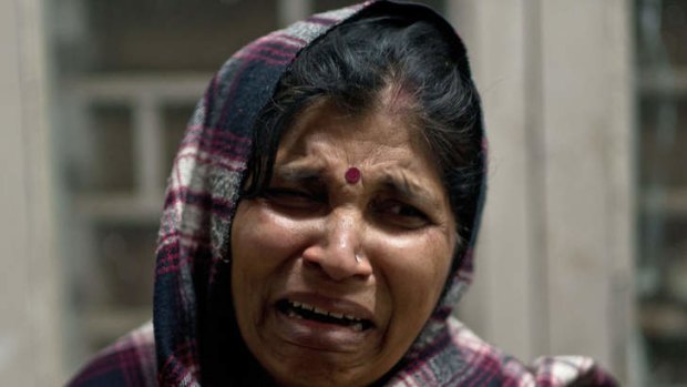 An Indian woman, caught in the stampede at the Railway Hospital in Allahabad, reacts after not finding a relative whom she last saw at the sight of the accident.