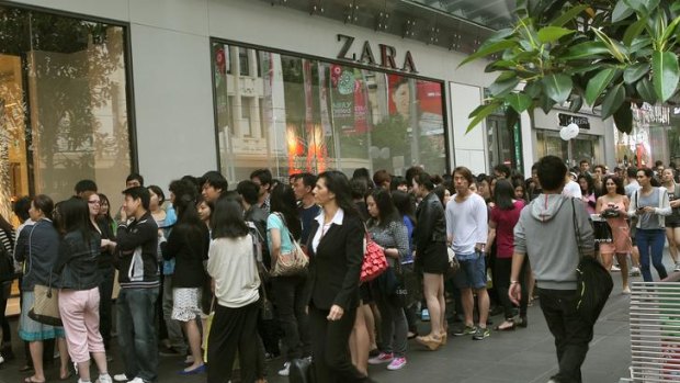 Customers line up outside fashion store Zara on Bourke Street yesterday morning.
