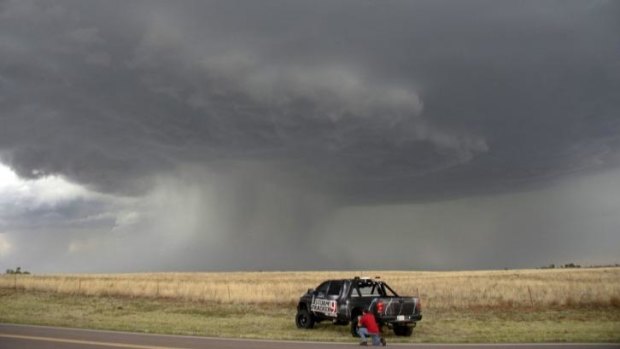 A photographer watches the storm pass through Vinson, Oklahoma, late on Sunday. Further severe storms were forecast for Monday.
