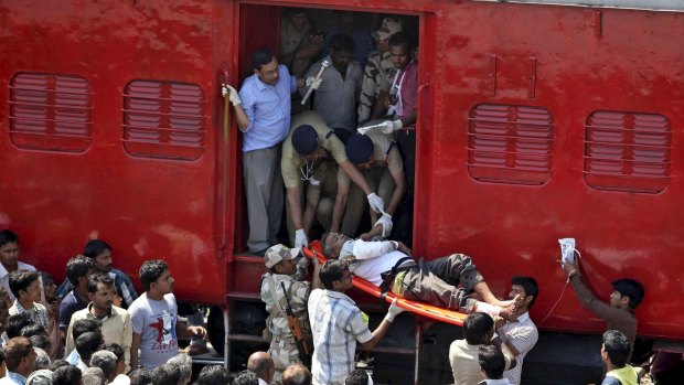 An injured passenger is being taken on a stretcher after a train accident at Rae Bareli district in the northern Indian state of Uttar Pradesh.