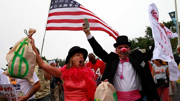 Stars and gripes ... protesters march on the Republican convention in Florida, which has been cut back by a day due to tropical storm Isaac.