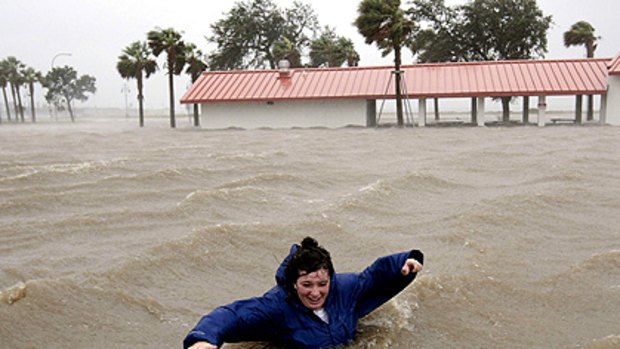 Sarah Salley walks through floodwaters on the New Orleans lakefront.