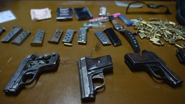 Hidden in socks ... Handguns used by the teenage attackers in the overnight Serena Hotel attack are displayed during a press conference. 